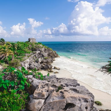 Tulum ruins overlooking white sand beach and turquoise Caribbean water